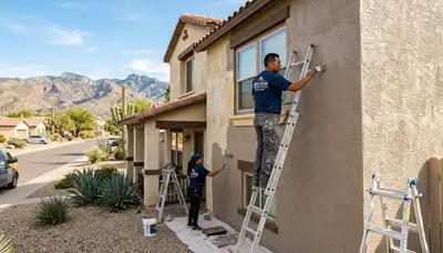 Professional house painters applying exterior paint to a Tucson AZ home for a smooth lasting finish